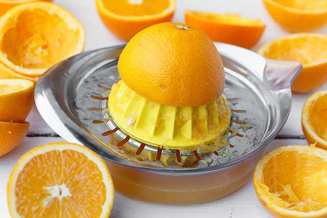 orange juice bottle with citrus splash and fresh oranges